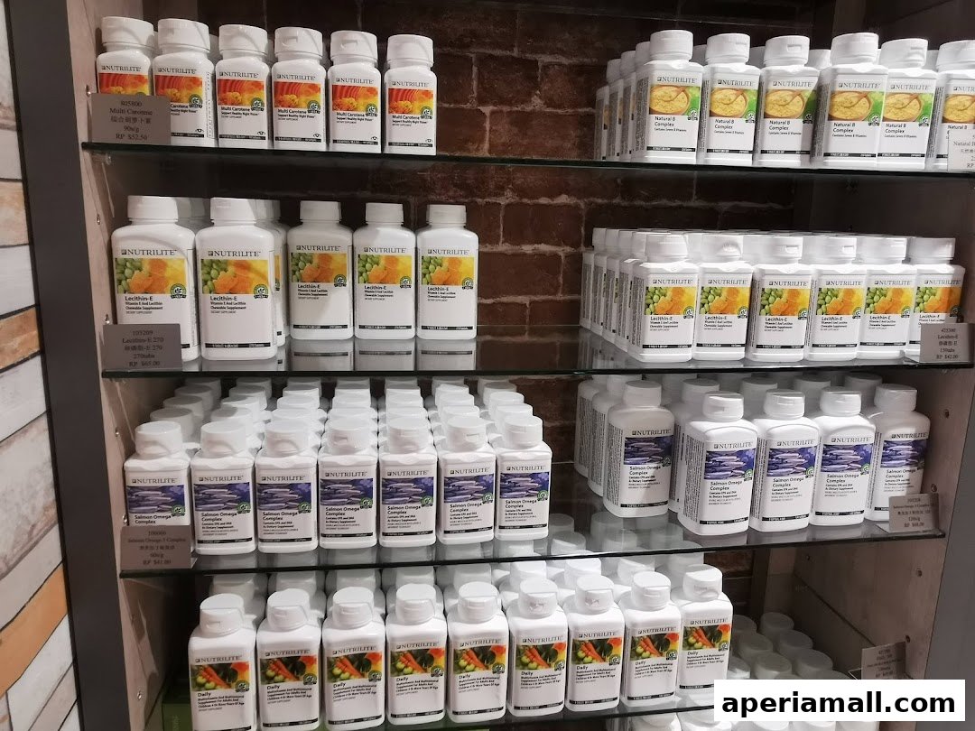 Shelves stocked with various Nutrilite health supplements in bottles and containers.