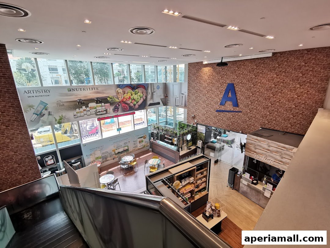 Interior view of a retail store with product displays, seating areas, and a cashier counter.