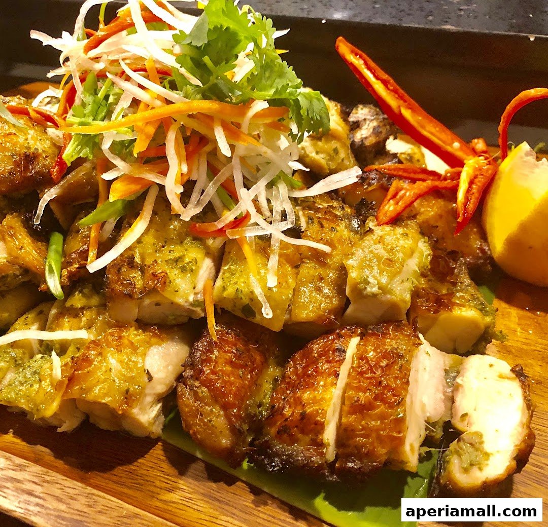 A close-up of a beautifully presented roasted chicken dish with fresh garnishes.