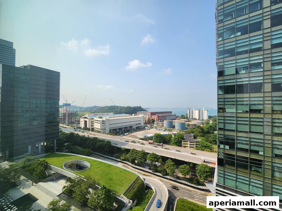 A panoramic view of a city skyline with modern buildings and a highway.