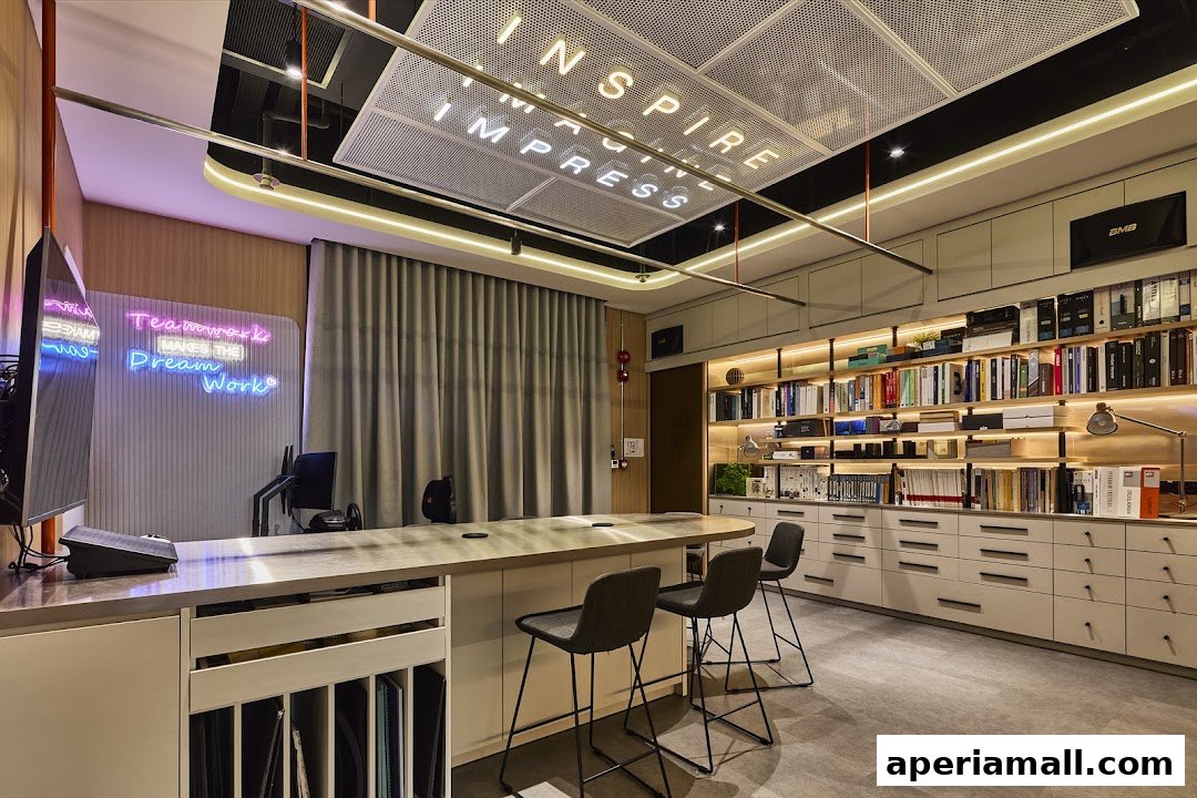 Modern office interior with a long desk, chairs, bookshelves, and neon signs.