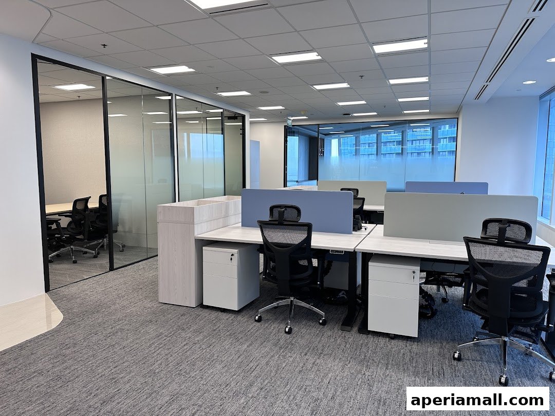 Modern office space with workstations, glass-walled meeting rooms, and city views.