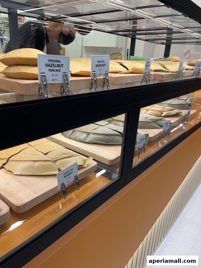 A display case filled with various flavors of pancakes at Ottie Pancakes.