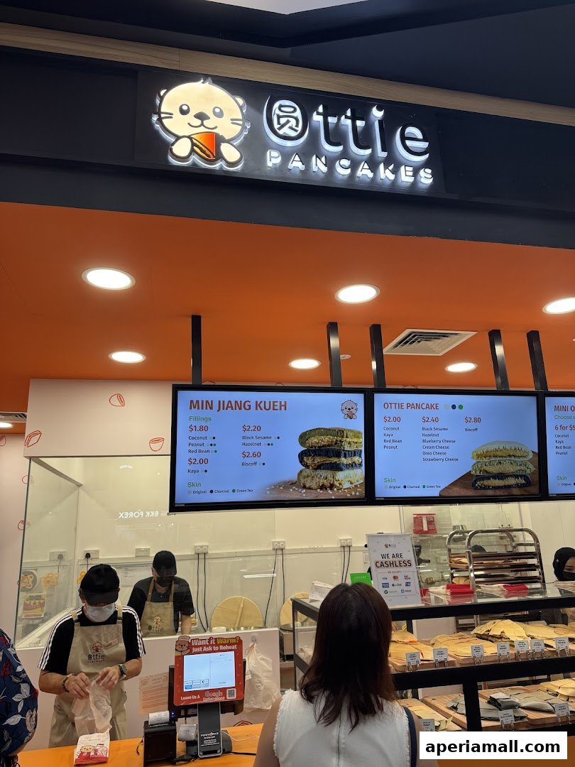 The Ottie Pancakes shop front with a menu board displaying various pancake options and staff serving customers.