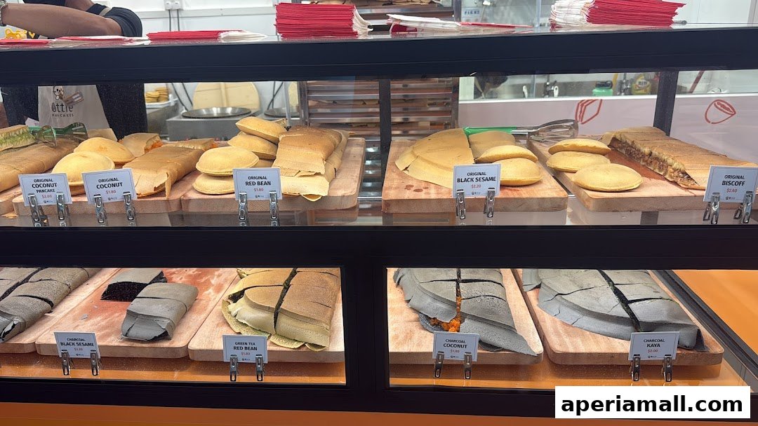 A display case filled with various flavors of freshly made pancakes and crepes.
