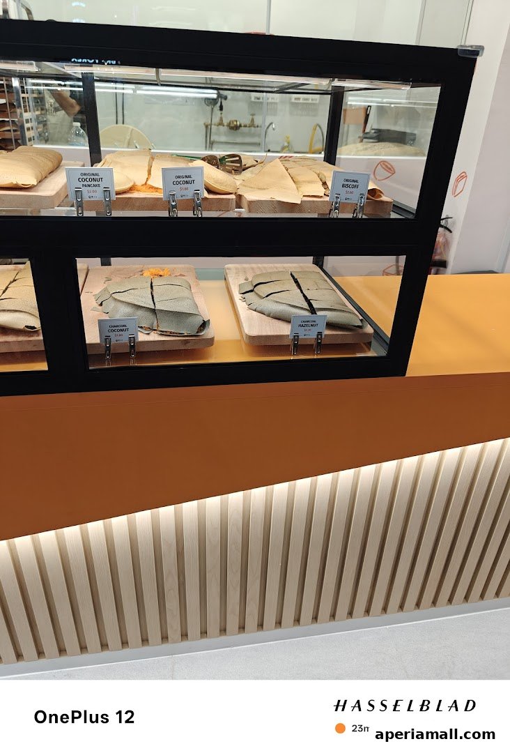 A display case filled with various flavors of pancakes, showcasing different fillings and toppings.