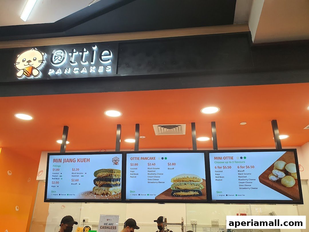 Digital menu boards displaying various pancake options and fillings at Ottie Pancakes.
