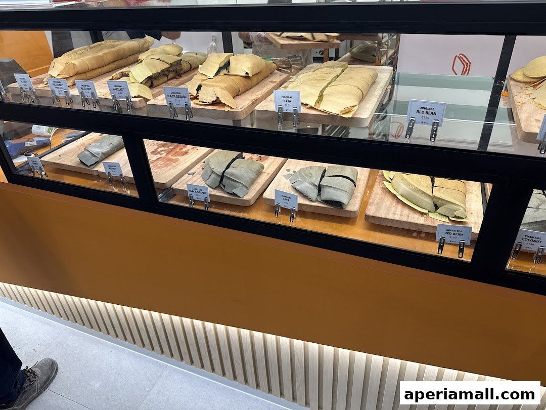 A display case filled with various flavors of pancakes, showcasing different fillings and toppings.