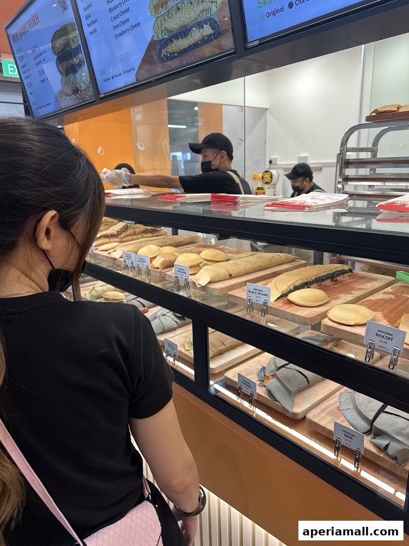 A customer looks at a display of freshly made pancakes at Ottie Pancakes.