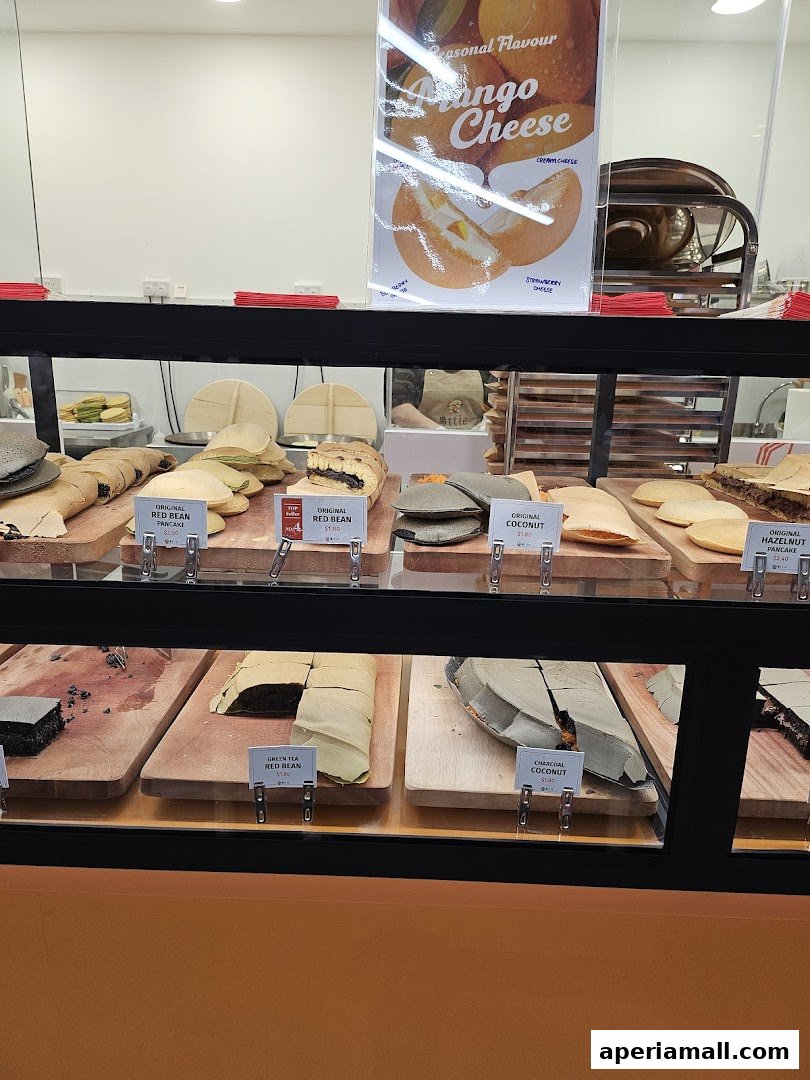 A display case filled with various flavors of Ottie Pancakes, including red bean and coconut.