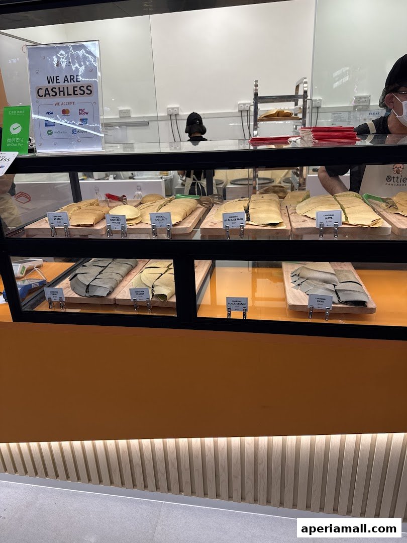 A display case filled with various types of pancakes at Ottie Pancakes.
