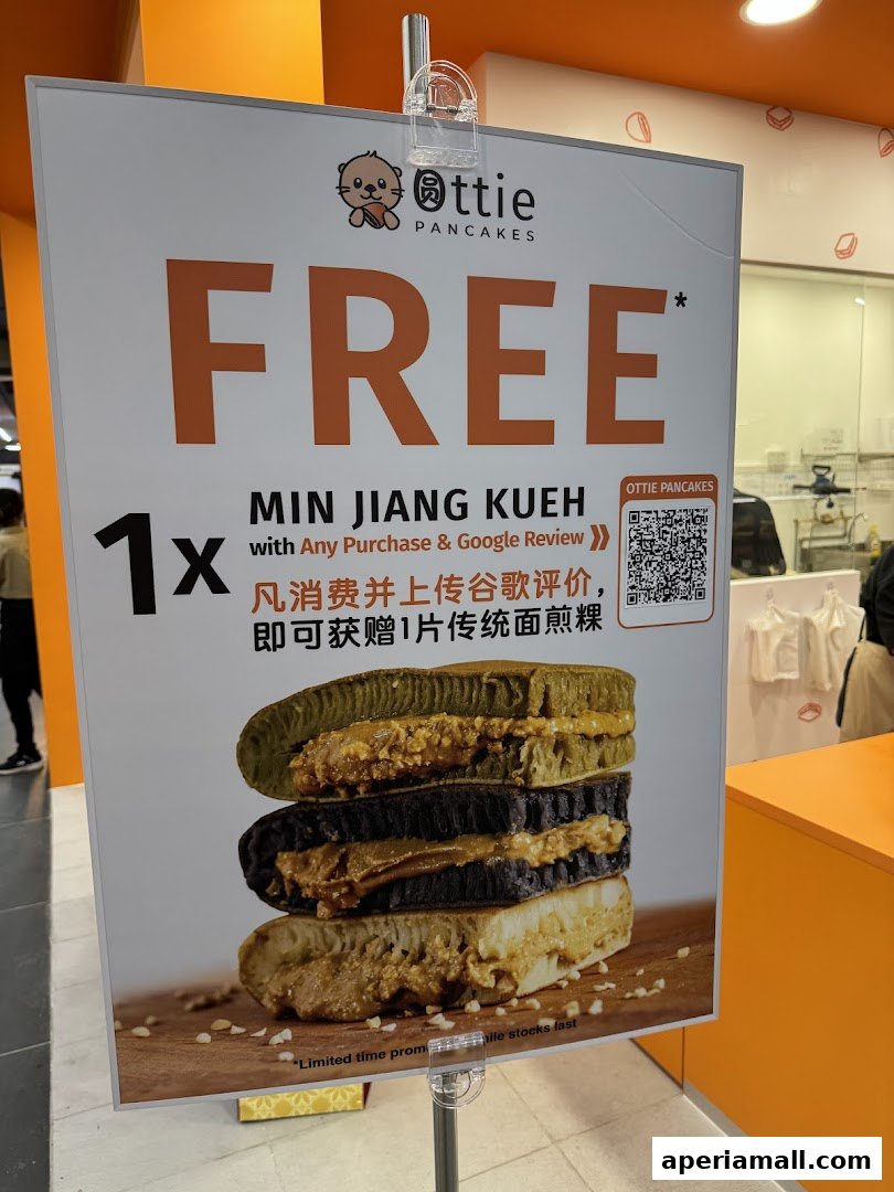 A promotional sign for Ottie Pancakes offering a free Min Jiang Kueh with purchase and review.