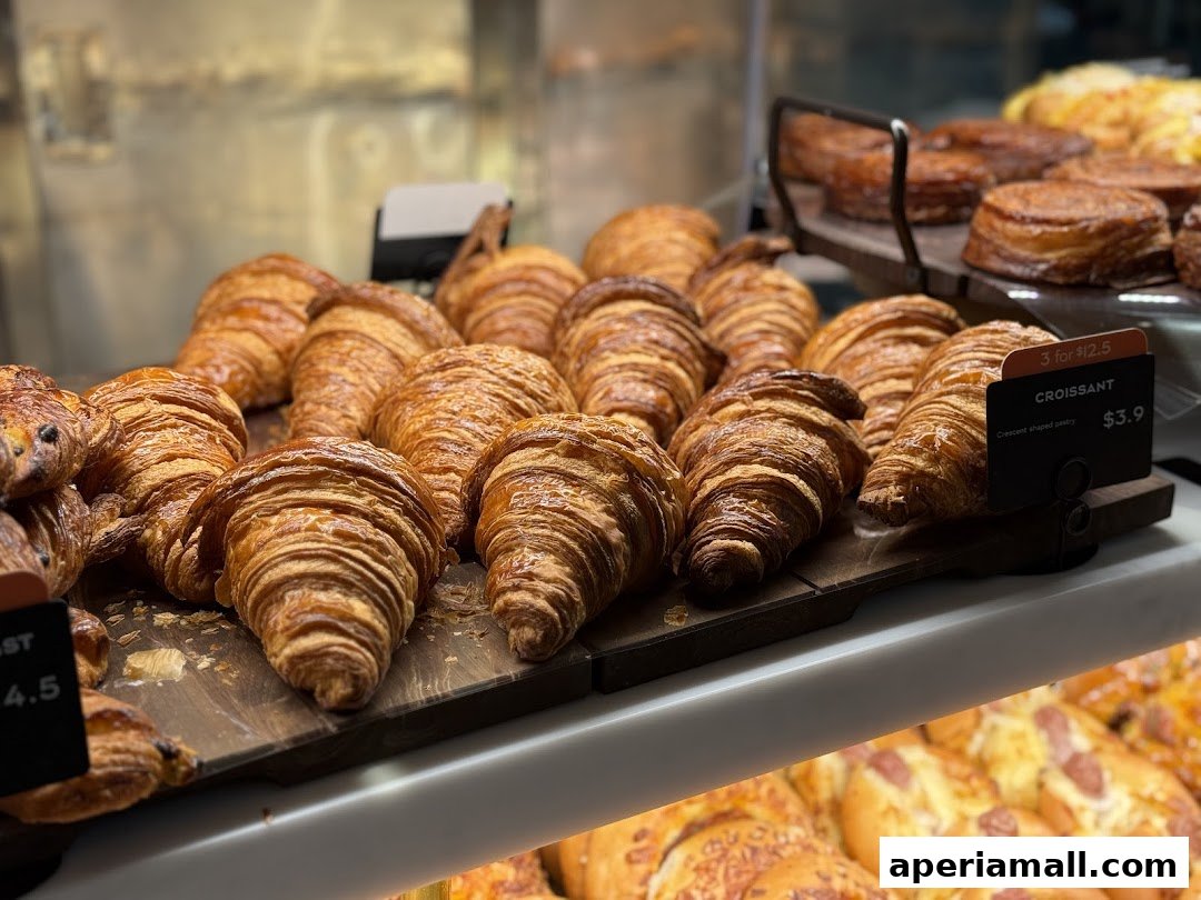 A display of freshly baked croissants and other pastries at Paris Baguette.