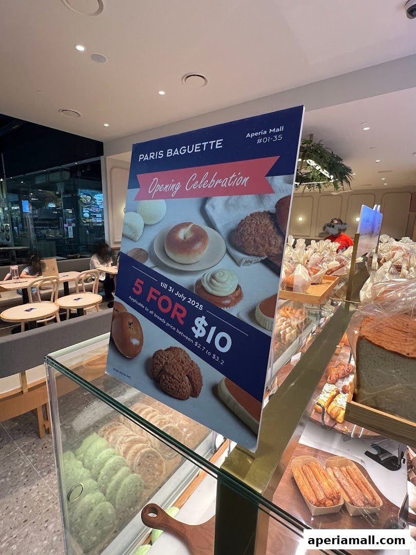 A sign for Paris Baguette's opening celebration with a special offer.