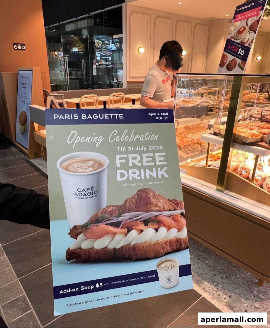 A sign advertising a free drink with sandwich or salad purchase at Paris Baguette.