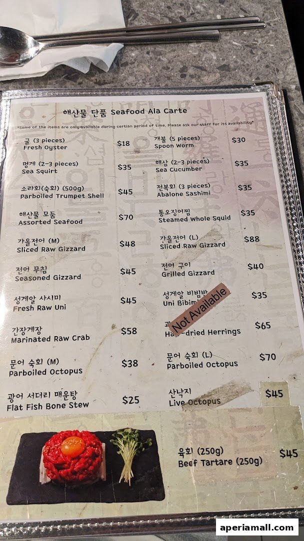 A menu from Pohang Seafood Butchery featuring a variety of seafood and meat dishes with prices.
