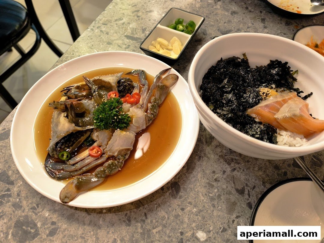 A close-up of two delicious Korean seafood dishes, marinated crab and a salmon rice bowl.
