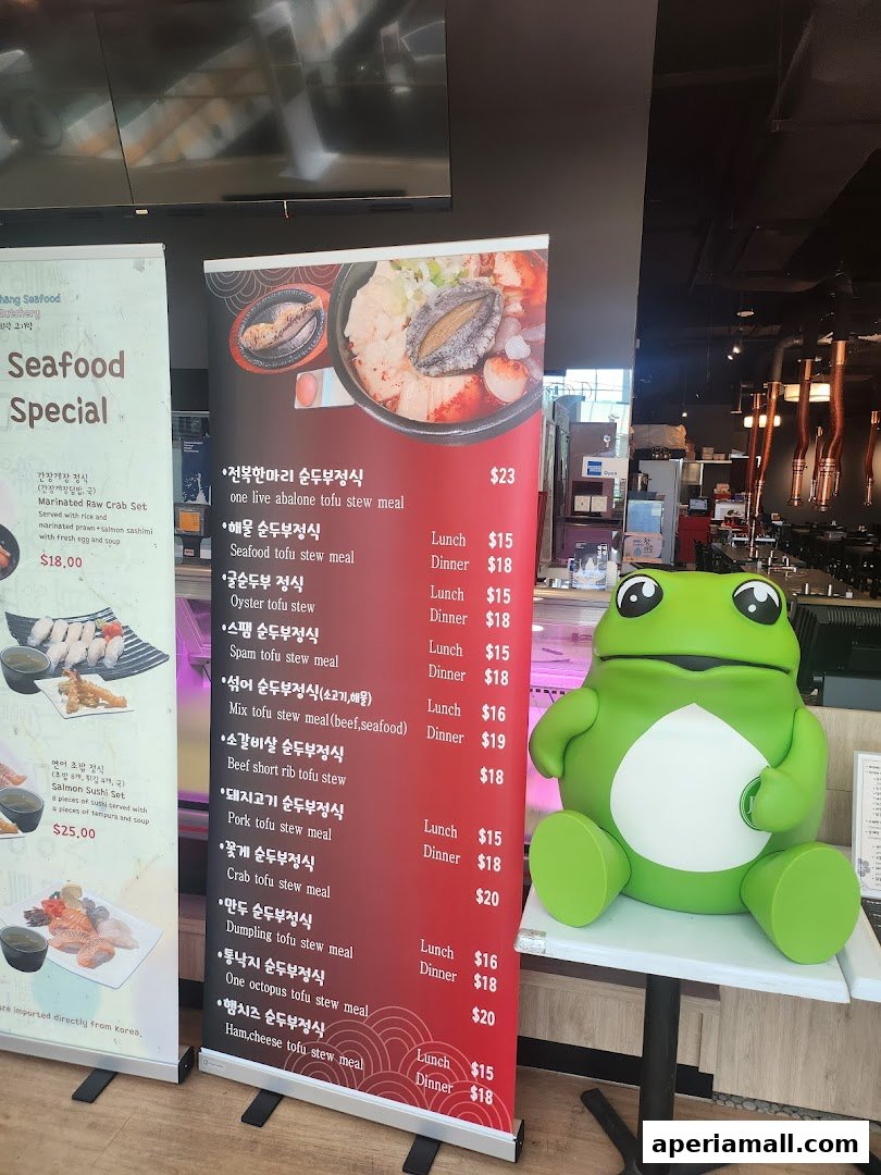 A display banner showcasing seafood specials and tofu stew meals with prices.