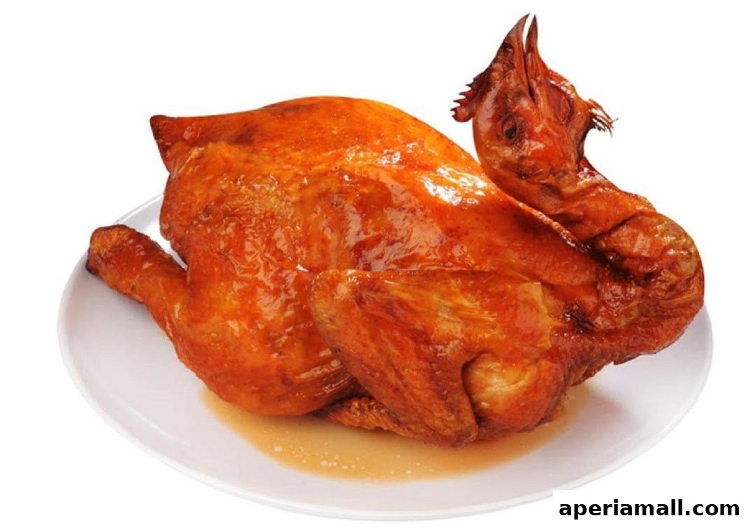 A whole roasted chicken with crispy golden-brown skin on a white plate.
