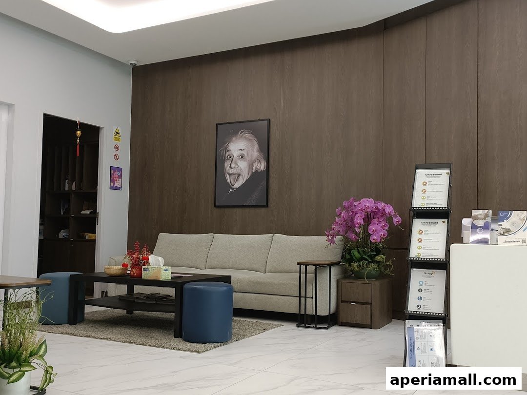 A waiting area with a couch, coffee table, and informational displays.