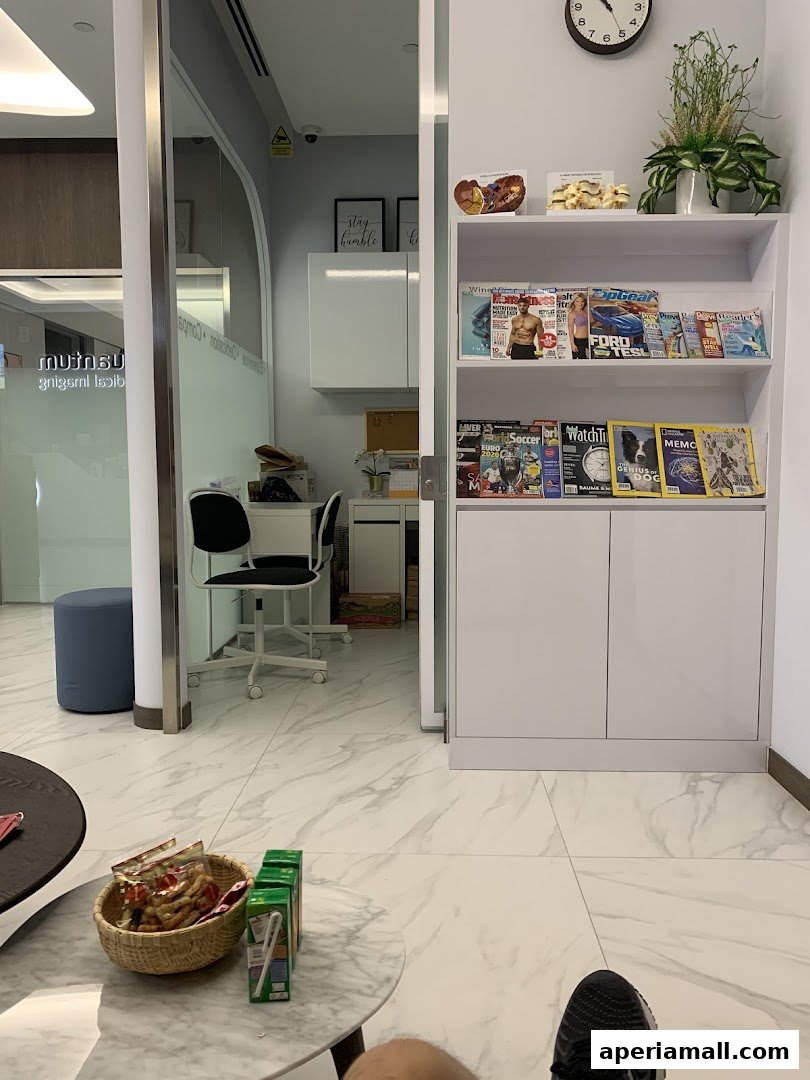 Interior waiting area with magazines, snacks, and a desk with chairs.