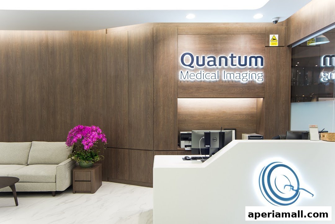 Reception area of Quantum Medical Imaging with a sofa, reception desk, and company logo.