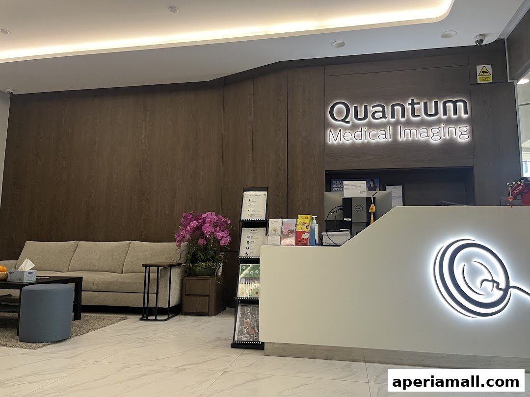 The reception area of Quantum Medical Imaging with a sofa, reception desk, and company logo.