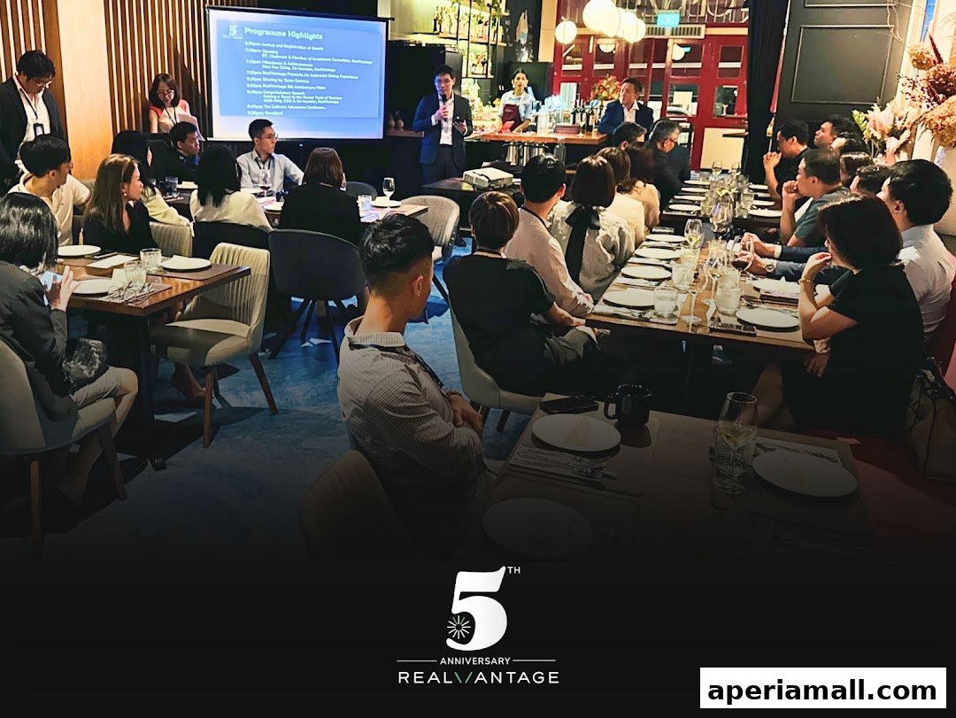 A group of people attend a presentation and dinner event at RealVantage.