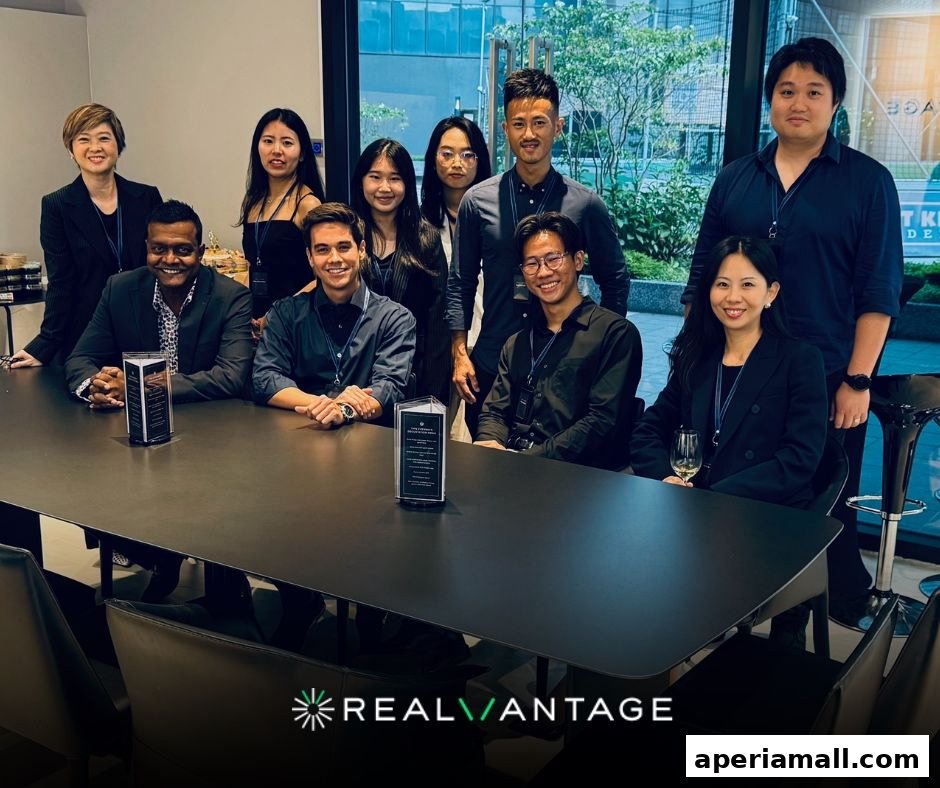 A diverse team of professionals posing around a conference table at RealVantage.