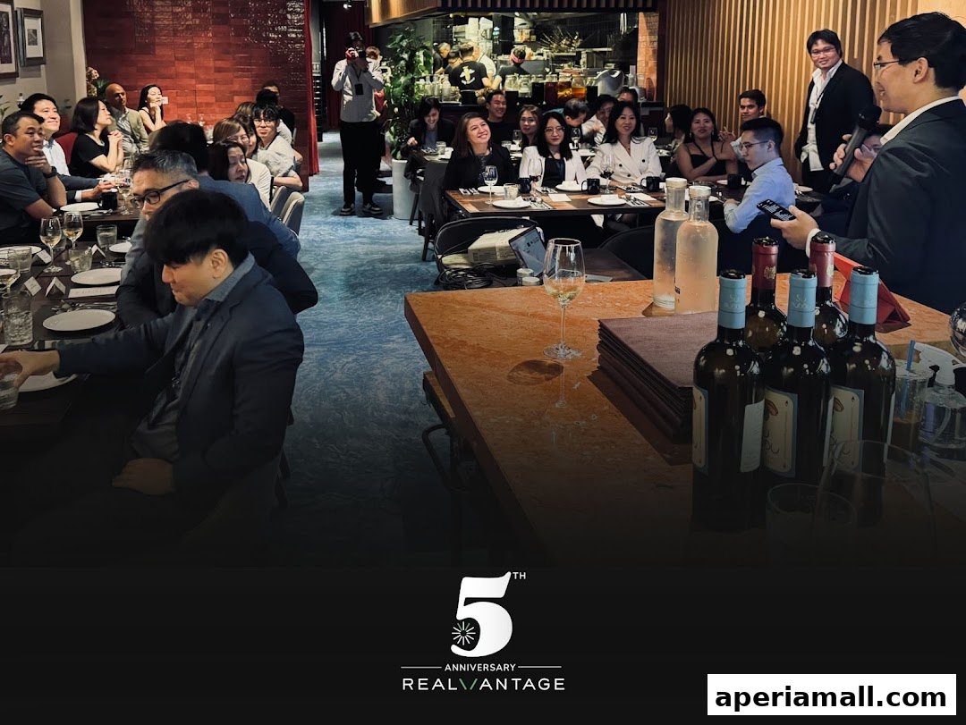 People gathered at tables in a restaurant, with a speaker addressing the group.