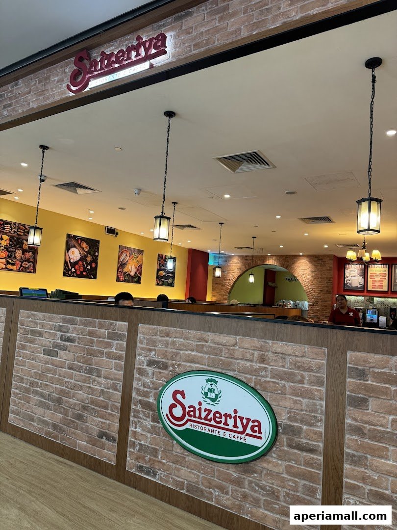 Interior view of Saizeriya restaurant with brick accents and hanging lamps.