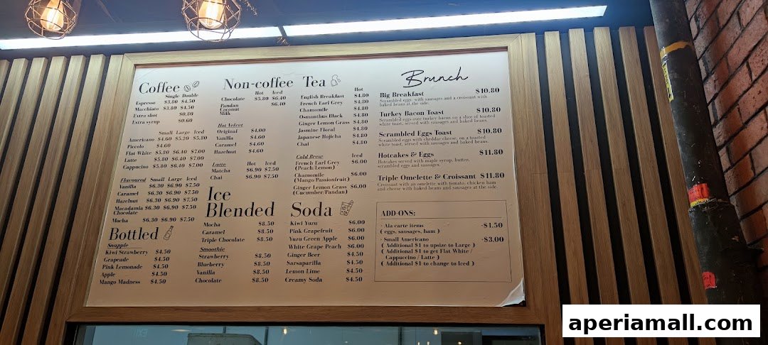 A menu board displaying coffee, tea, brunch, ice blended drinks, sodas, and bottled drinks with prices.
