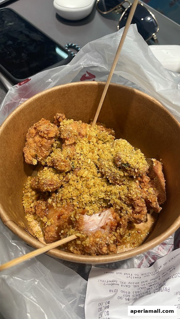 A close-up of Shihlin Taiwan Street Snacks' signature fried chicken with a crispy topping.