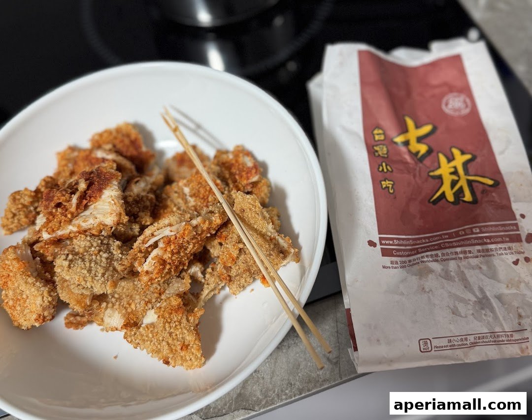 A plate of crispy fried chicken and a branded paper bag from Shihlin Taiwan Street Snacks.
