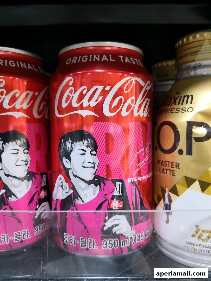 Coca-Cola cans featuring BTS member RM and a Maxim coffee drink.