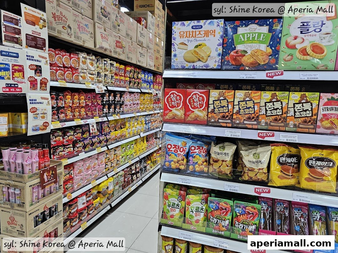 A wide selection of Korean snacks and drinks displayed on shelves in a retail store.