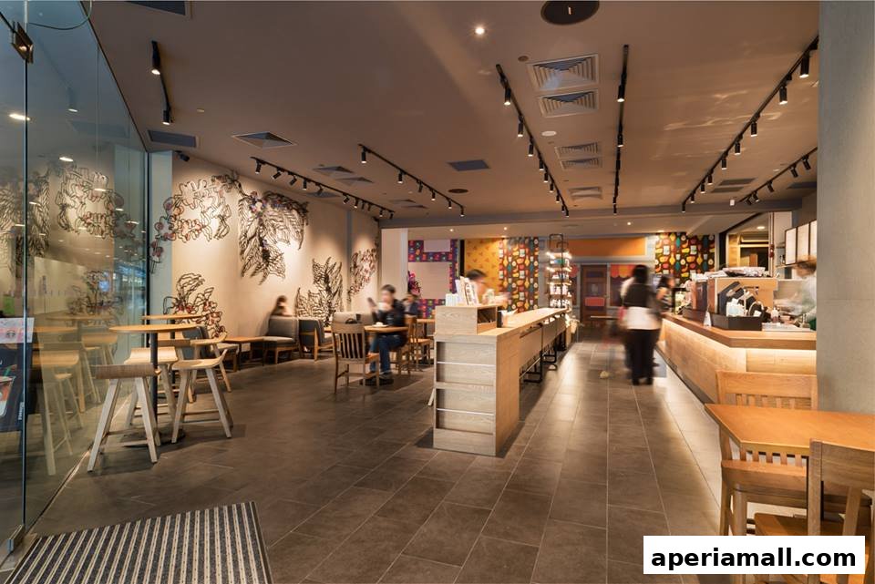 Interior view of a Starbucks coffee shop with seating areas and a counter.