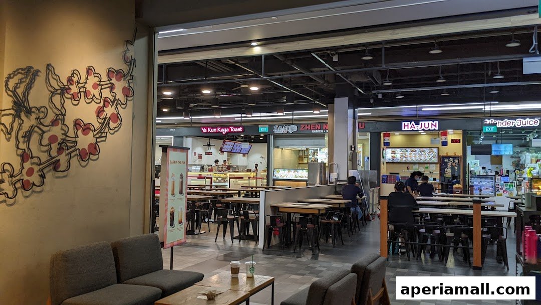 Interior view of a Starbucks with seating and other food stalls visible in the background.
