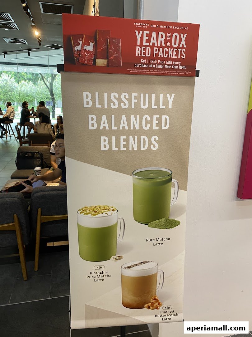 A promotional banner for Starbucks featuring new latte flavors and Lunar New Year red packets.