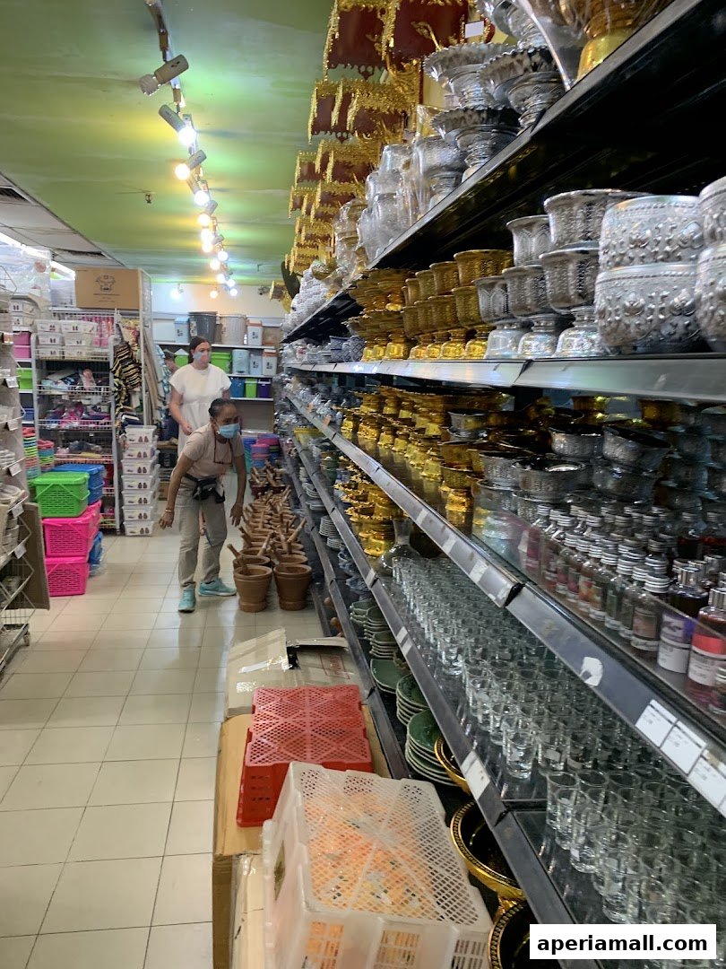 Interior view of a Thai supermarket with shelves stocked with various kitchenware and decorative items.