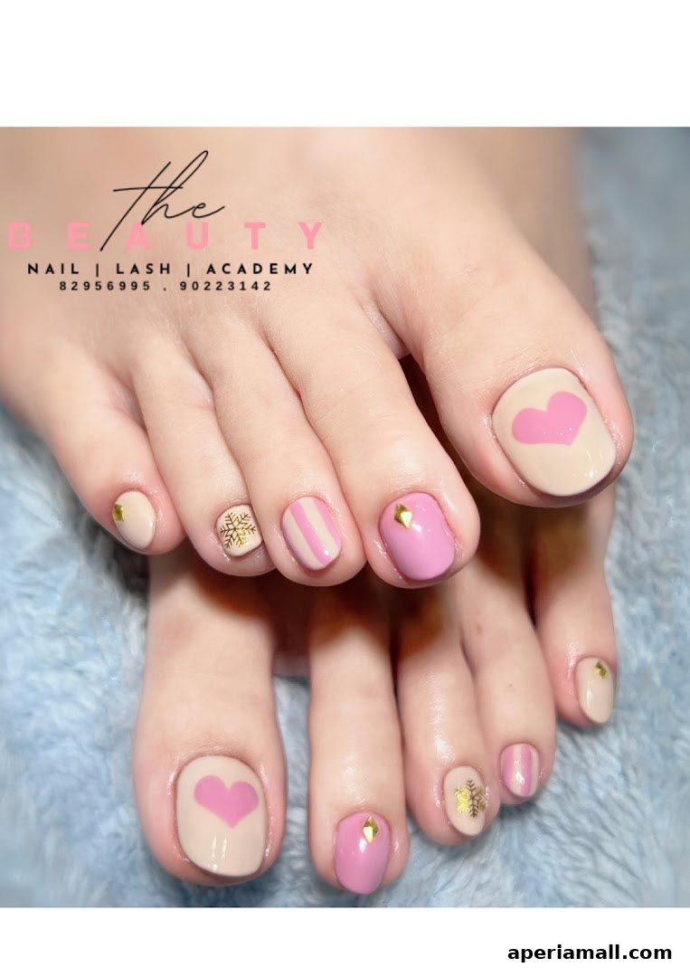 Close-up of feet with beautifully decorated toenails featuring hearts, stripes, and snowflakes.