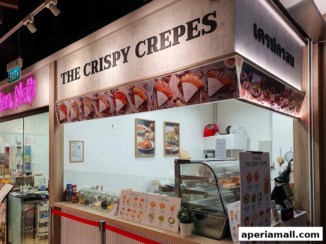 The Crispy Crepes shop front with a display of crepes and menu items.