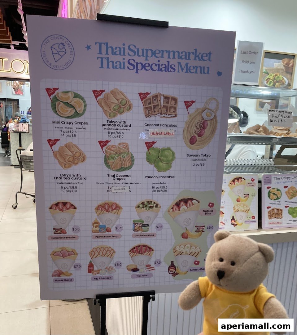 A menu board for The Crispy Crepes featuring various Thai-inspired crepes and pancakes.