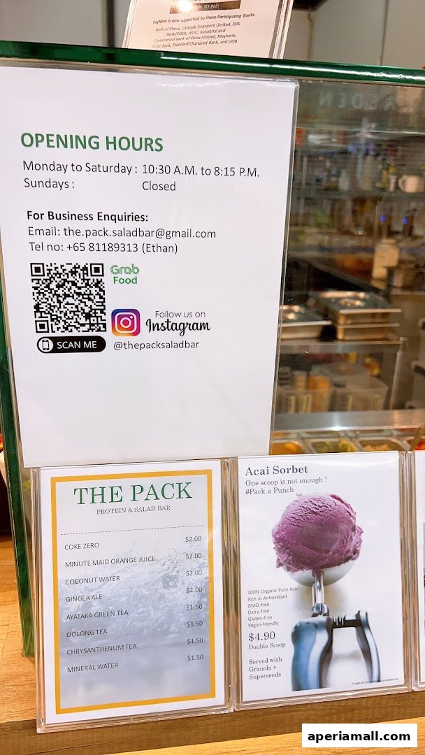 A menu board for The Pack Protein & Salad Bar, featuring drinks and Acai Sorbet.