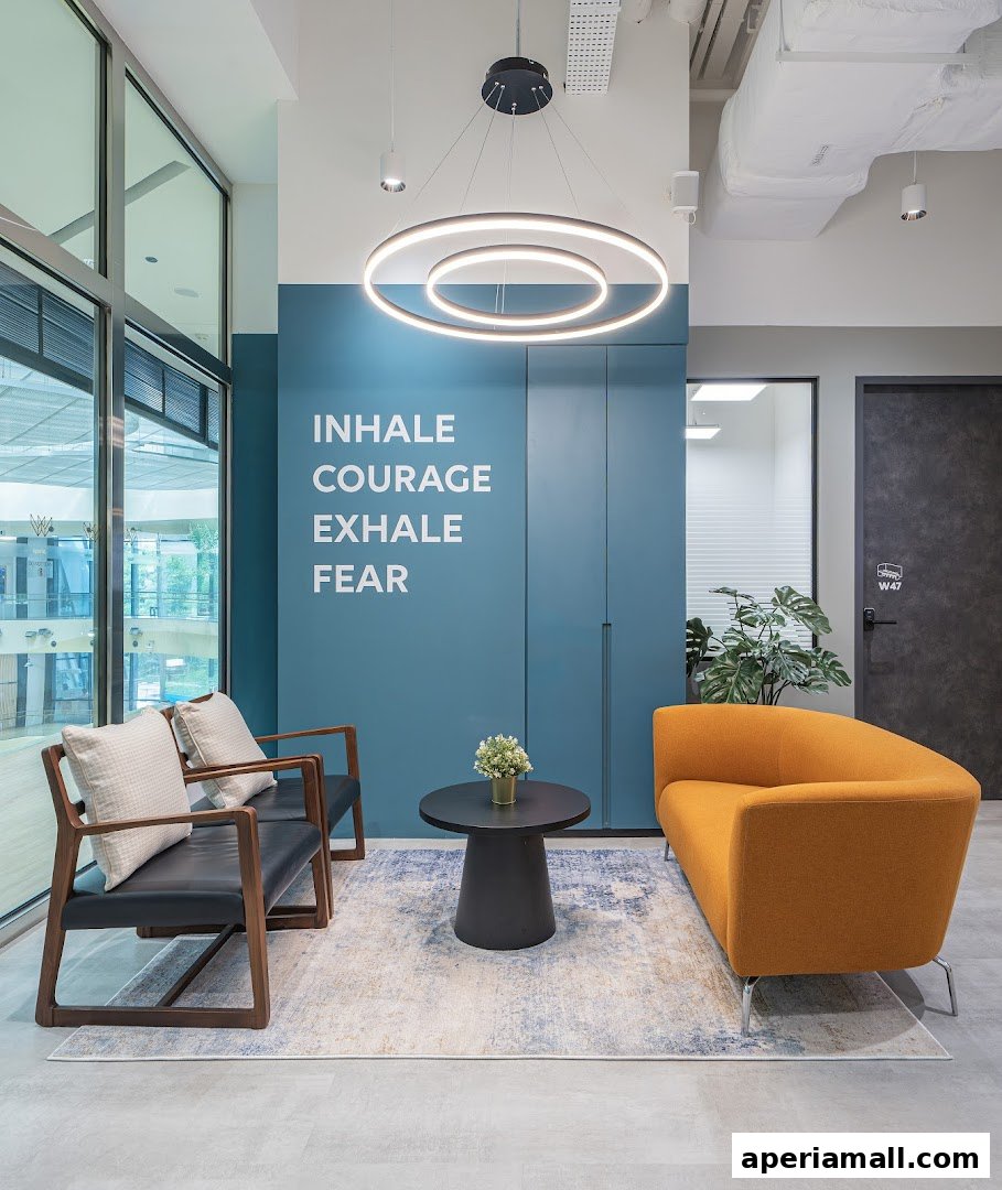 A modern waiting area with motivational text on a blue wall and comfortable seating.