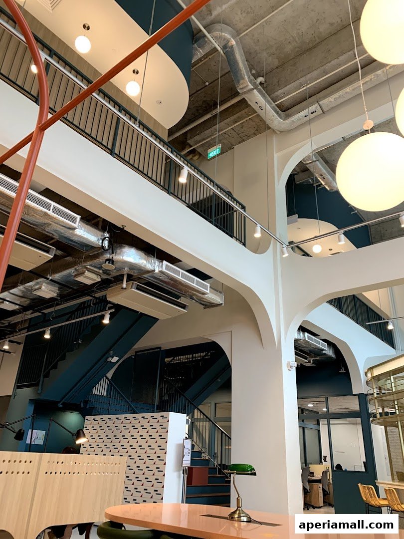 Interior view of a modern multi-level space with industrial design elements and seating areas.