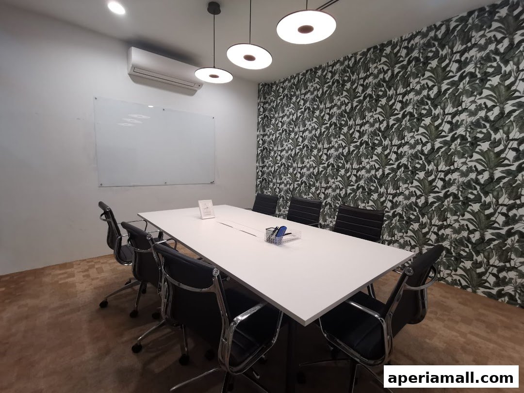A modern meeting room with a large table, chairs, whiteboard, and botanical wallpaper.