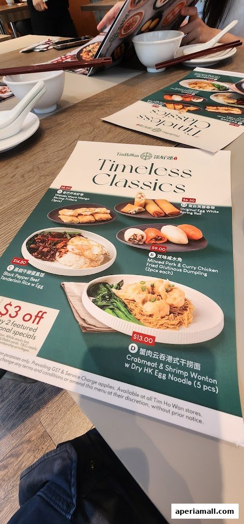 A menu from Tim Ho Wan featuring various classic dishes with prices and descriptions.