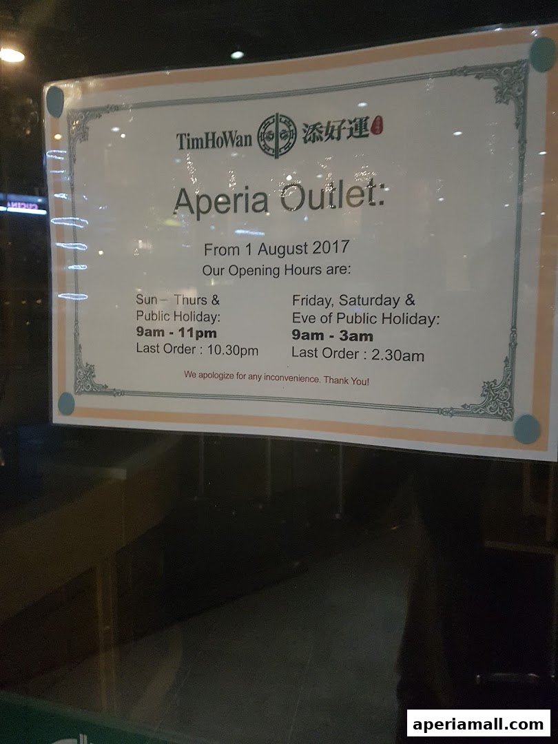 A sign displays the opening hours for Tim Ho Wan's Aperia Outlet.