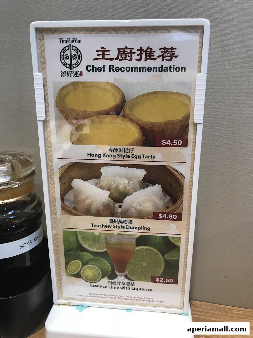 A menu board from Tim Ho Wan featuring chef recommendations like egg tarts, dumplings, and a lime drink.